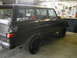 1977 Jeep Wagoneer - A black 1977 Jeep Wagoneer is shown in a garage setting, a "BJ's Off-Road" sticker on the rear window.