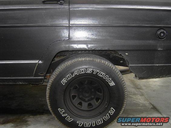 1977 Jeep Wagoneer showing rear wheel well and part of the body panel