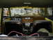 1977 Jeep Wagoneer - Interior view of a 1977 Jeep Wagoneer, worn seats and a cluttered dashboard.