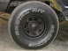 1977 Jeep Wagoneer - A close-up view of a vehicle's tire, showing the brand name and tire type in white lettering.