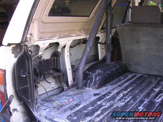 Interior cargo area with roll bar and worn flooring