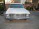 1966 Ford Ranchero - A white 1964 Ford Falcon is shown from the front, parked on a cracked concrete driveway with plants in the background.