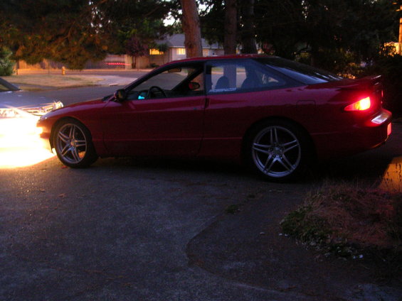 red 1996 Ford Probe coupe parked on driveway, side view
