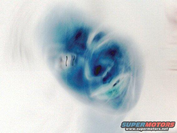 Abstract blue and white blur with some dark shapes and faint vertical lines
