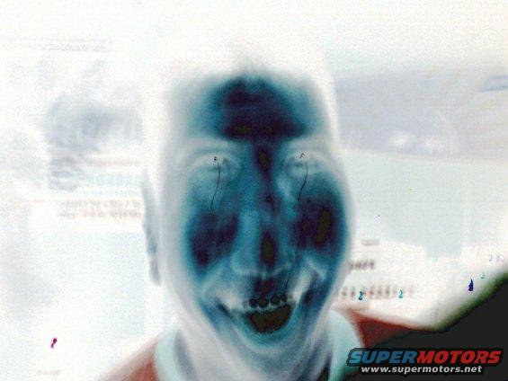 Distorted face with wide smile and dark eyes