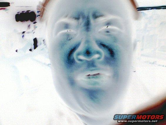 Inverted image of a person's face with Supermotors.net logo in the corner