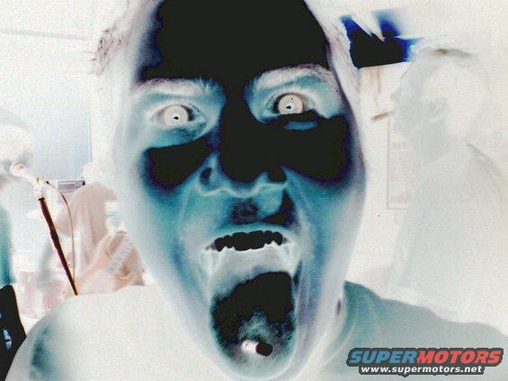 Person with mouth open and eyes wide, inverted colors