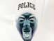 2001 Ford Crown Victoria - An inverted photograph shows a person's face with the word POLICE visible on their hat.