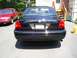 2003 Mercury Marauder - A black 2003 Mercury Marauder is parked in a driveway next to a red sedan.