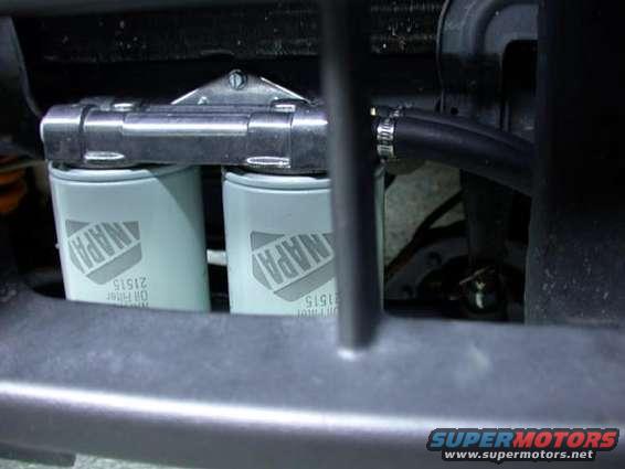 Two NAPA oil filters mounted together with a hose attached