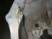 1993 Ford Taurus - A gray plastic automotive part with yellow tape is shown in a close-up view.