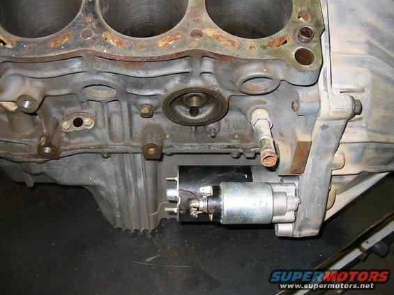 Close-up of an engine block and starter motor assembly