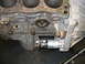 1993 Ford Taurus - This image shows a close-up view of an engine block and its attached starter motor.