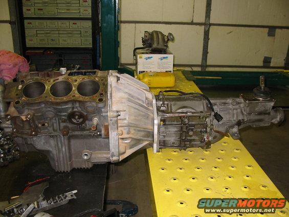 Engine block and transmission assembly on yellow platform