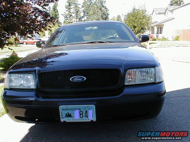 Front view of a dark blue 2002 Ford Crown Victoria with a Washington license plate
