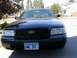 2002 Ford Crown Victoria - A dark blue 2002 Ford Crown Victoria is parked in a driveway on a sunny day.