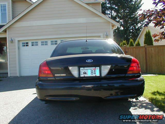 Black 2002 Ford Crown Victoria rear view parked in driveway