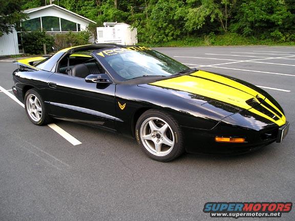 Black 1994 Pontiac Trans Am with yellow racing stripes and yellow roof