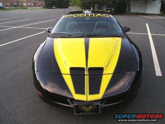 Black and yellow Pontiac Trans Am with racing stripes on the hood