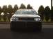 2003 Volkswagen GTI - Front view of a black 2003 Volkswagen GTI with headlights illuminated.