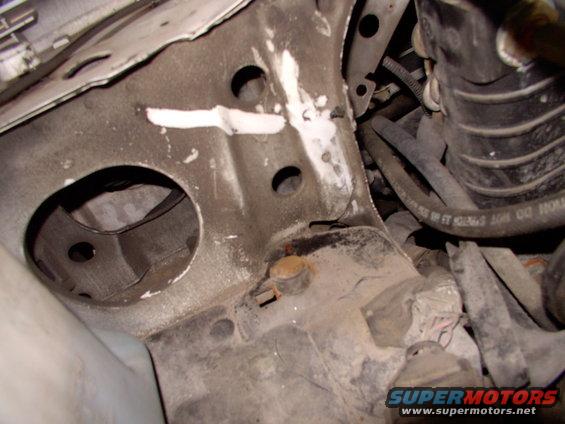 The space between the rad and the sheet metal bulkhead is almost big enough to allow a fresh air tube through as is. The hole to the left is where the tiny stock plastic "trumpet" passes through to suck air from behind the headlight.