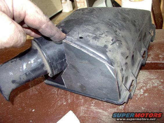 Plate ready to accept tubing (once a hole is cut into it).The small hole in the airbox is the drain hole (remember this is the bottom of the airbox so "it" is upside down in the pic).