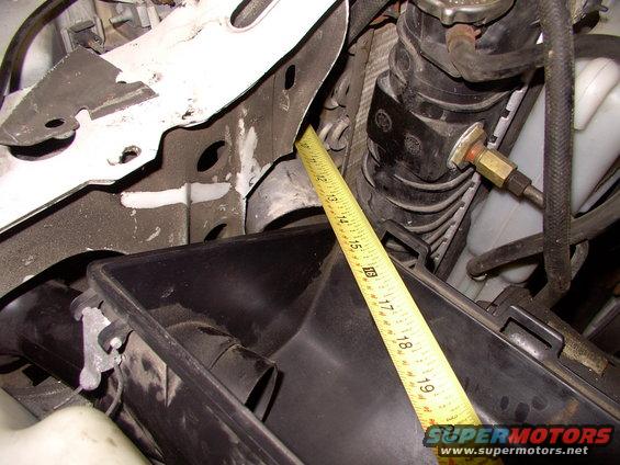 A little Sawzall work (see the cut out piece of sheetmetal on top of the support) and there's some room. Yes heathens, that is a 3" pipe passing through to the boxed area behind the grill. Probably end up using smaller pipe though. Didn't even have to move the horns !