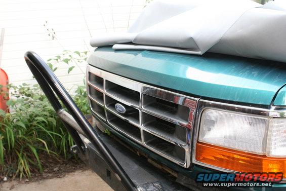 Green 1990 Ford Bronco front grille with chrome and bull bar