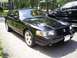 2003 Mercury Marauder - A black 2003 Mercury Marauder sedan is parked on a street, with another black vehicle behind it.