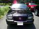 2003 Mercury Marauder - Front view of a black 2003 Mercury Marauder parked in a driveway, with other vehicles visible.