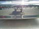 2003 Mercury Marauder - The Marauder emblem is visible on the trunk of a car, with a reflection of a person and another vehicle.
