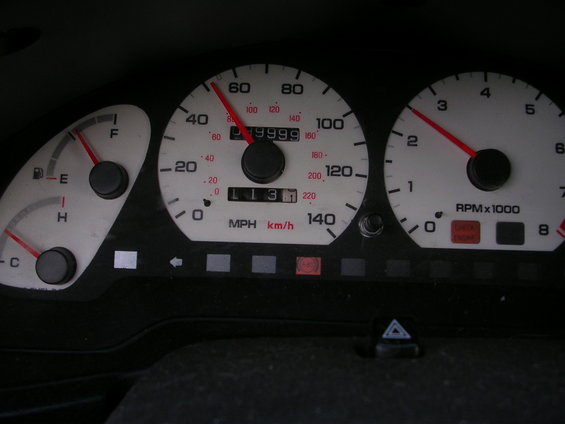 Car dashboard with speedometer reading 40 mph and odometer showing 199999 miles