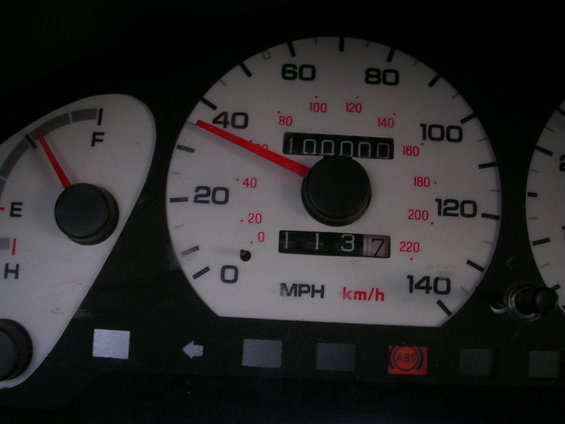 Odometer shows 100000 miles on dashboard gauges