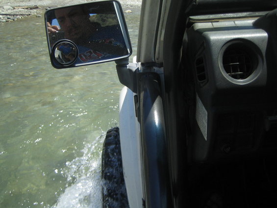 1987 Suzuki Samurai driving through shallow water, side view from interior