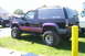 2006 Ford Supercrewzer - This lifted Chevrolet Blazer has custom paint and is parked on grass next to another vehicle.