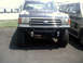 1996 Ford Bronco - This lifted truck, likely from the late 1980s, is shown from the front with a winch mounted below the bumper.