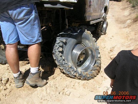 Off-road vehicle with a flat tire on a dirt road