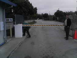 Gate 4a with a barrier arm and two people