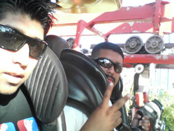 Two men wearing sunglasses on a roller coaster ride