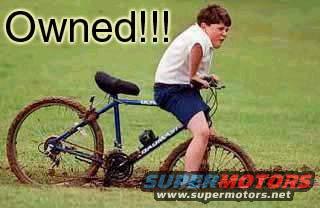 Boy on a blue bicycle stuck in mud, with "Owned!!!" text overlay