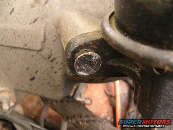 Close-up of a bolt on a metal engine component