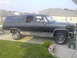 1990 Chevrolet Suburban - Side view of a black 1990 Chevrolet Suburban with silver trim.