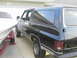 1990 Chevrolet Suburban - This 1990 Chevrolet Suburban is parked next to a boat on a trailer.