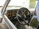 1990 Chevrolet Suburban - The interior of a classic Chevrolet truck shows its dashboard with woodgrain accents and a prominent steering wheel.