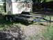 1997 Ford Crown Victoria - A car hauler trailer is shown parked outdoors on a grassy area, with a shed in the background.
