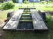 1997 Ford Crown Victoria - Rear view of a car hauler trailer a wooden deck and metal ramps, with a "Supermotors.net" watermark.