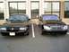 2003 Mercury Marauder - A black 2003 Mercury Marauder is parked in front of a building, alongside another black sedan.
