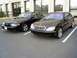 2003 Mercury Marauder - Two black sedans, a 2003 Mercury Marauder and a Mercedes-Benz S-Class, are parked in a lot.