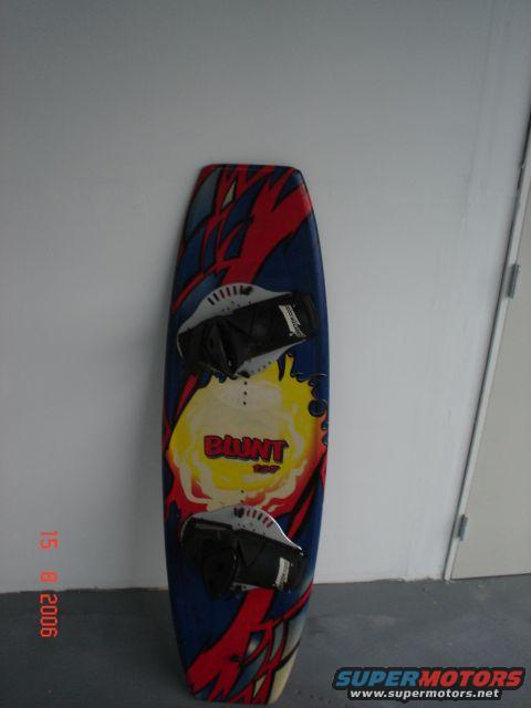 Wakeboard with red, blue, and yellow graphics and "BLUNT" text