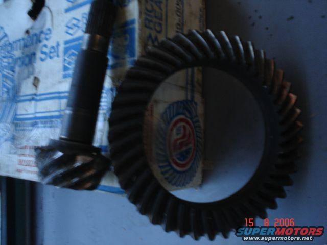 Differential gear set with a pinion gear and ring gear, partially in packaging